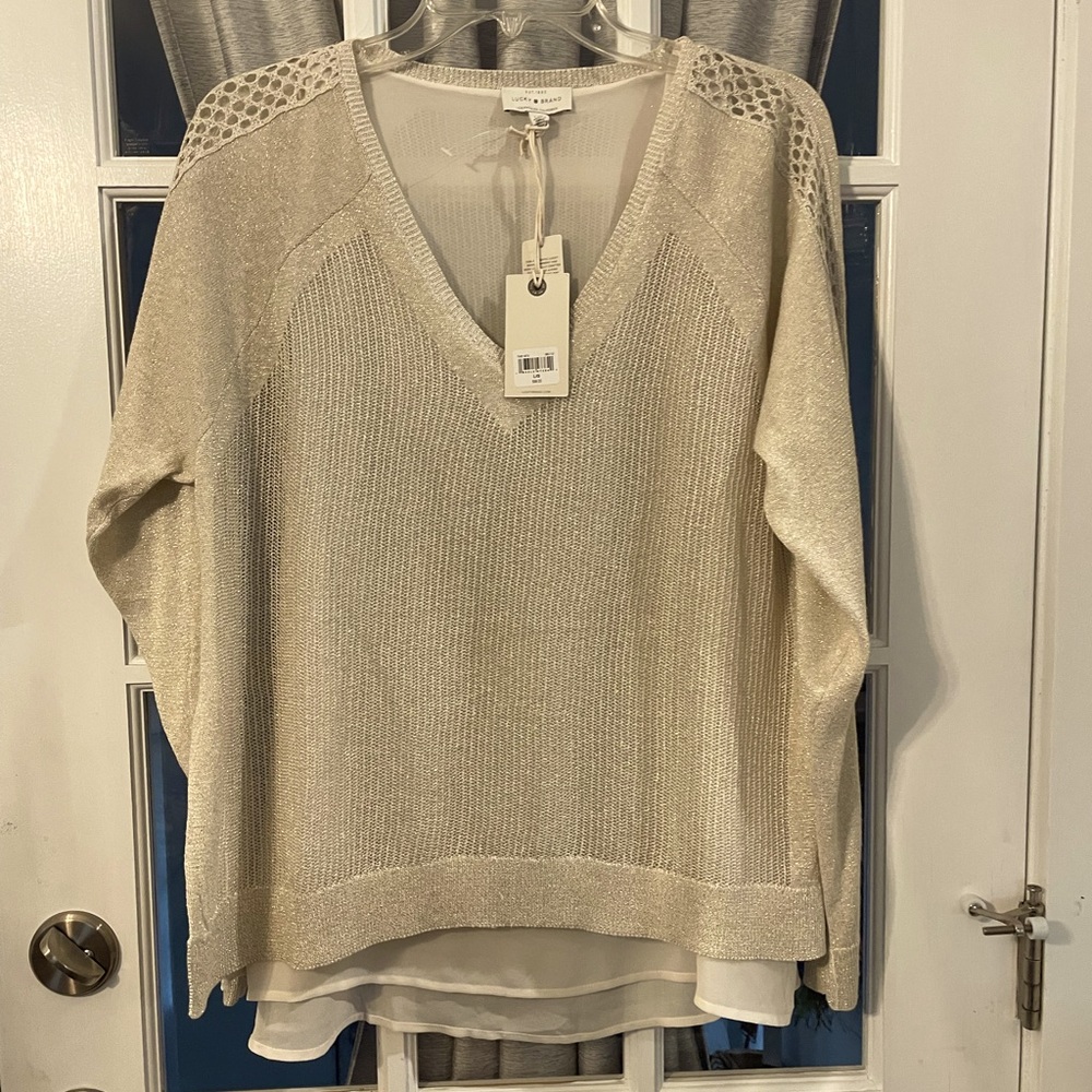 Woman’s sweater gold with underlining cream colored tank